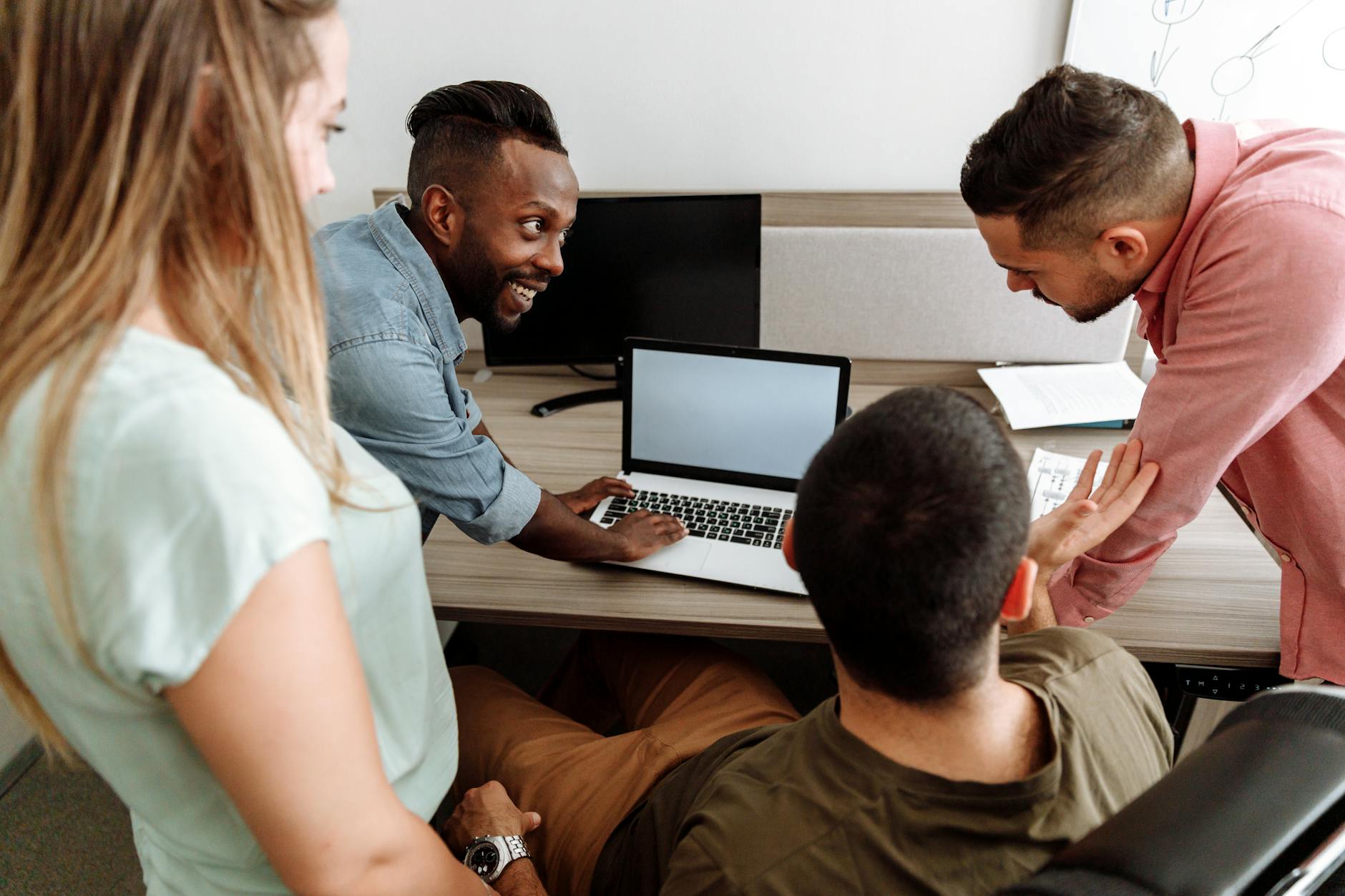 Group Of People Having Discussion At Work