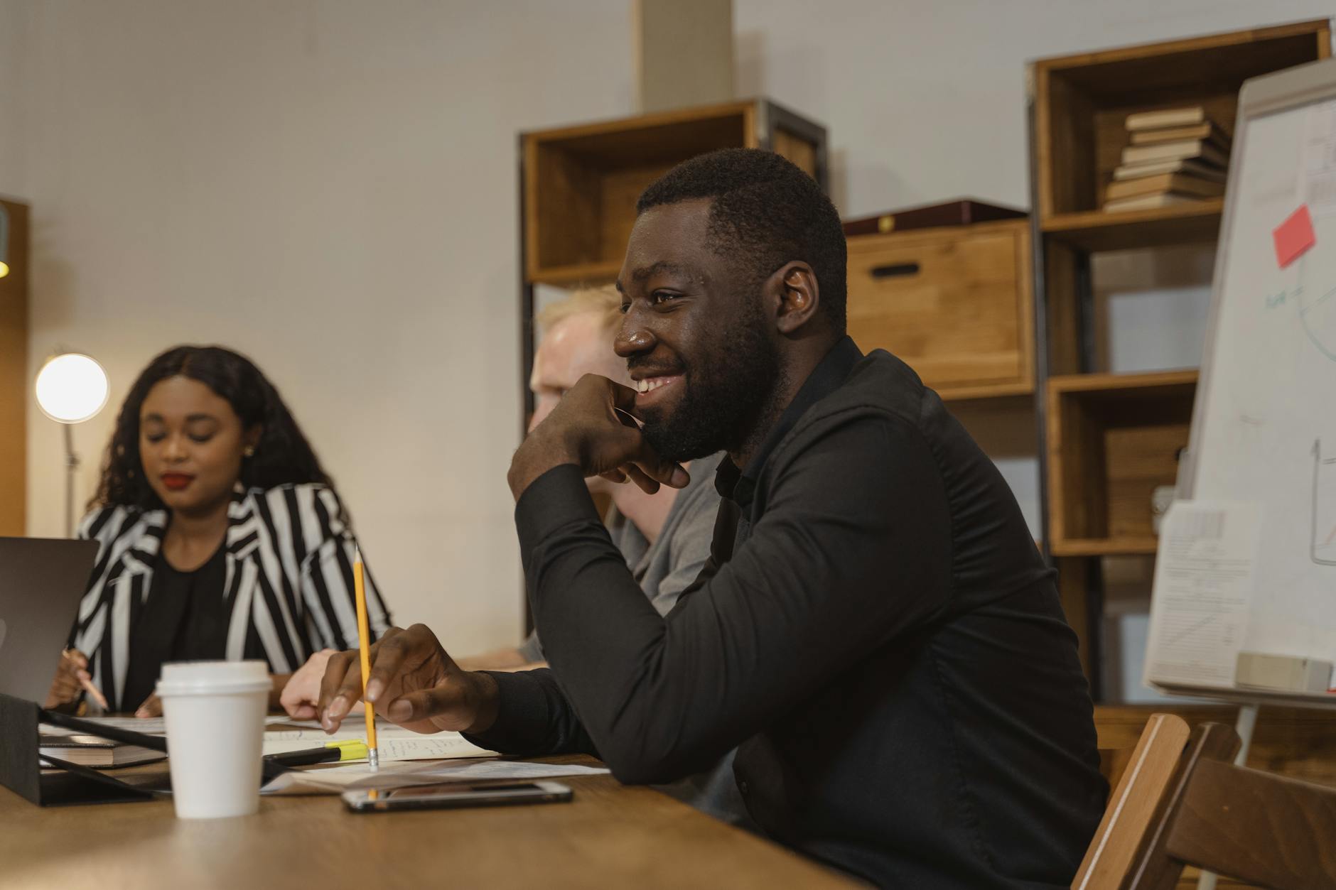 Man in Black Long Sleeve Shirt Sitting at the Table