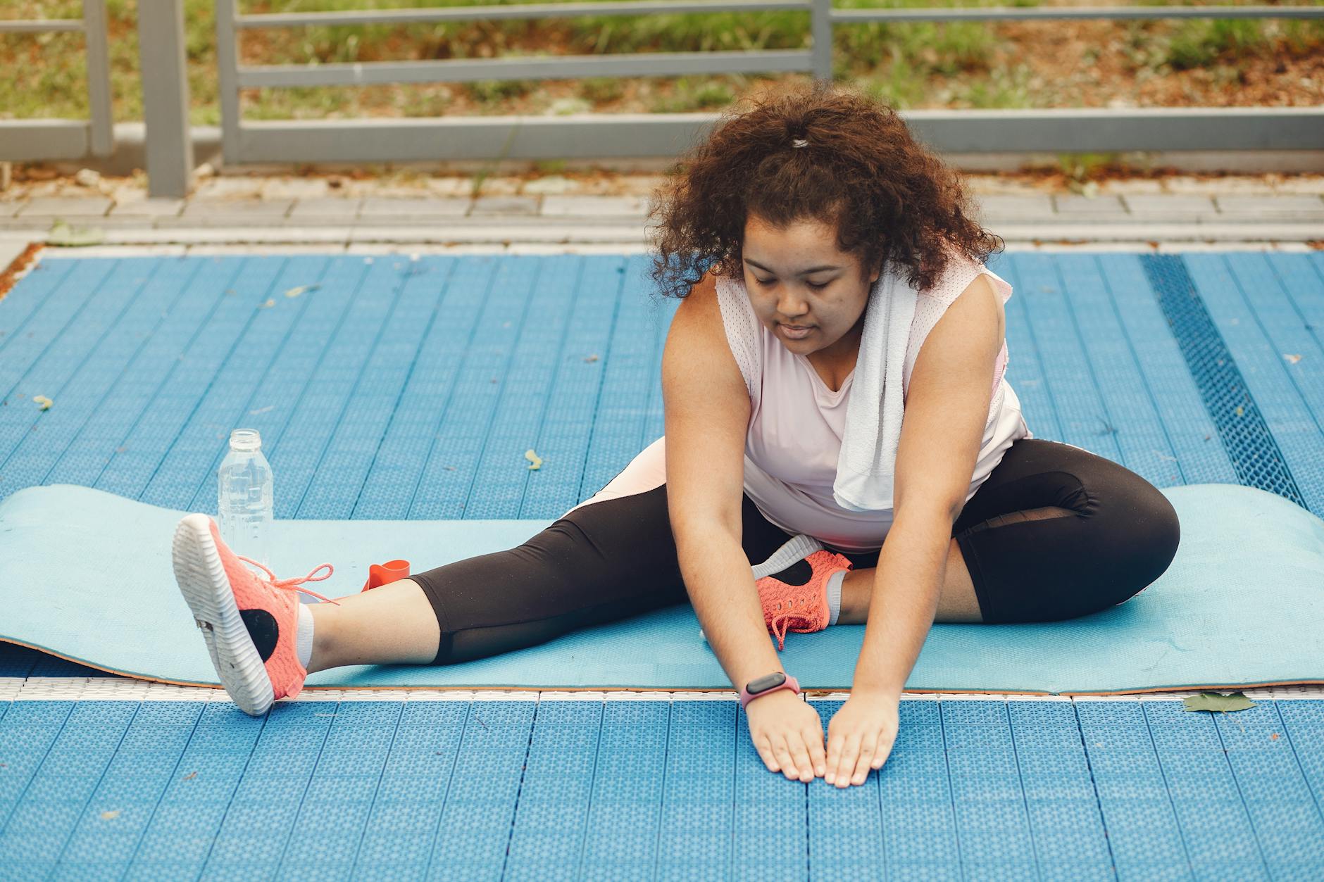 A Woman in Activewear Stretching